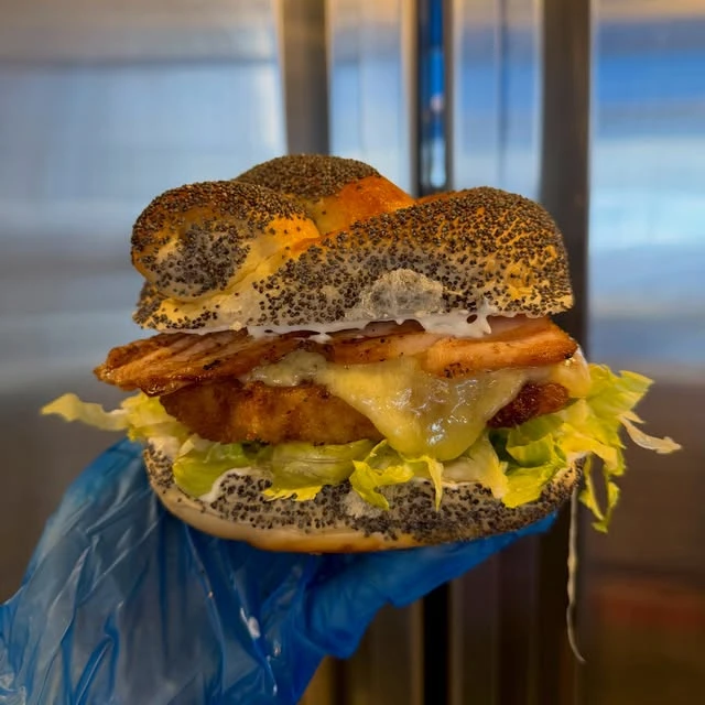 Schnitzel and pastrami turkey in a seeded challah roll