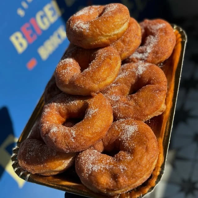 Sugar-coated doughnuts on a tray at Beigel Bar